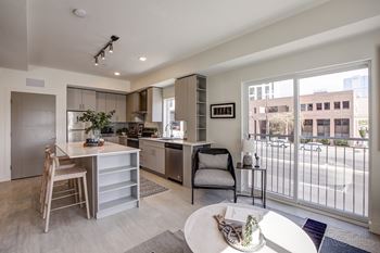 A modern kitchen with a dining table and chairs.